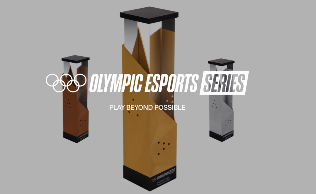 Three trophies, one gold, one silver, one bronze, are in the background, with the words Olympic Esports Series in the foreground next to the traditional Olympic logo. 